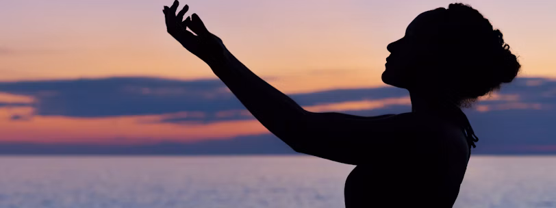 silhouette of woman raising her right hand